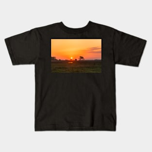 Sunset over the meadow Kids T-Shirt